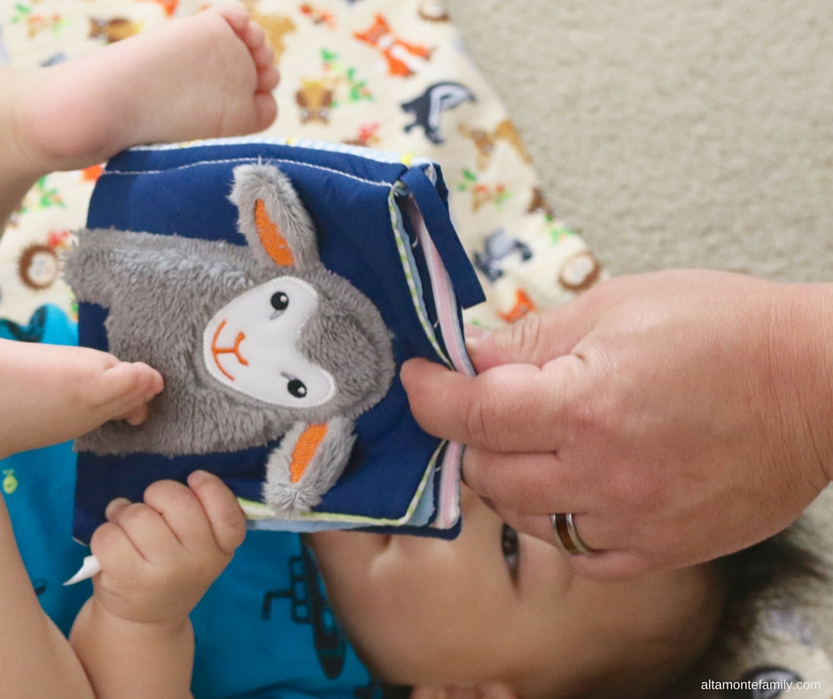 Dad reading and playing with baby